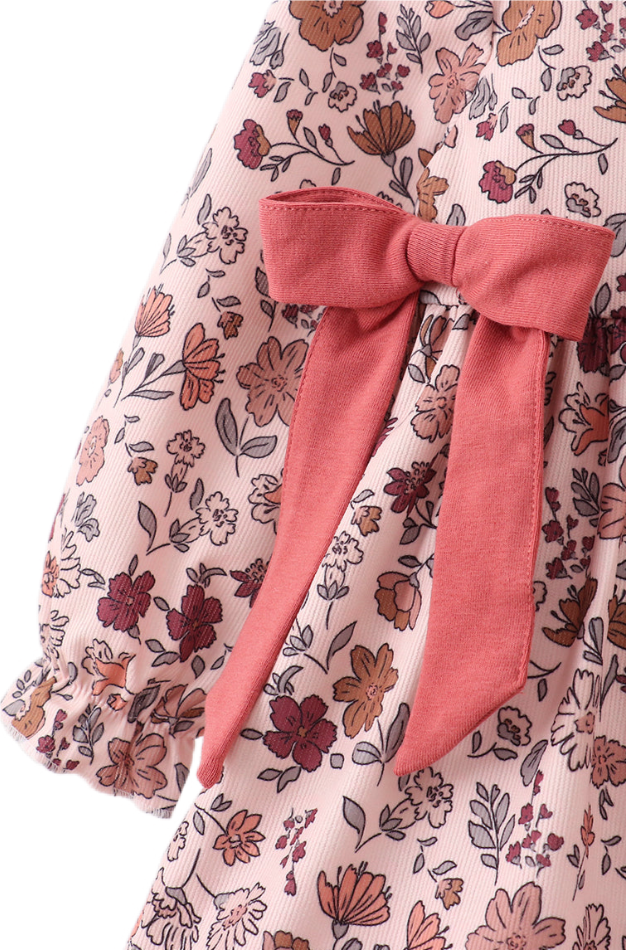 Two baby girl autumn outfits in soft corduroy with warm floral prints. One is a romper with ribbon details, and the other is a pants and top set, both in matching fall tones.